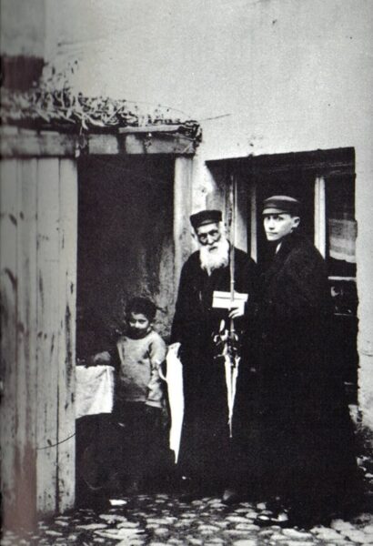 Rodzina żydowska w Kaliszu przed wejściem do szałasu (kuczki). Lokalizacja nieznana. Zbiory Hili Marcinkowskiej